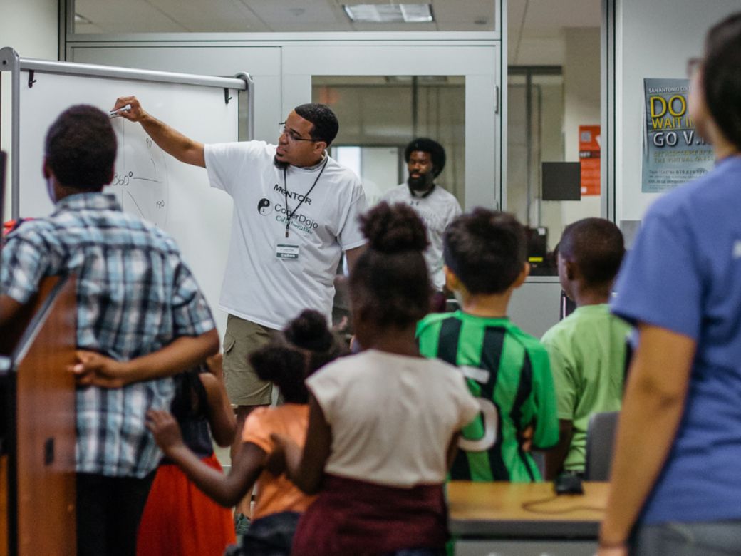 CoderDojo mentor writes on whiteboard